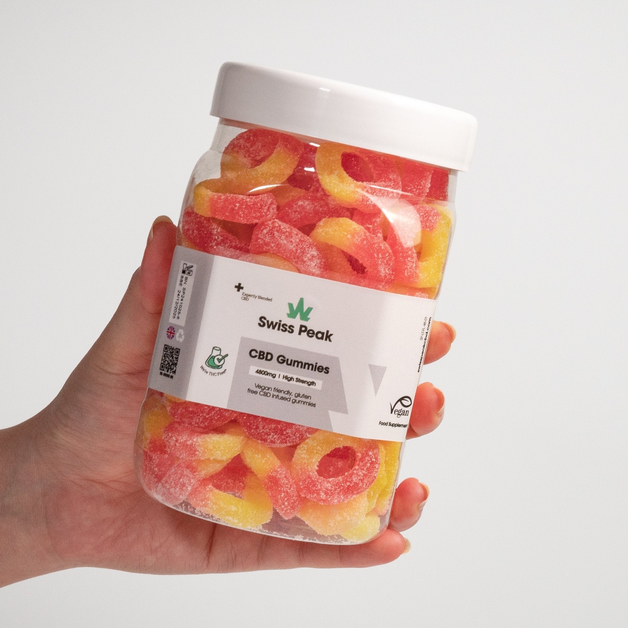 Hand holding CBD Peach Ring Gummies 3200mg - 4800mg - Swiss Peak